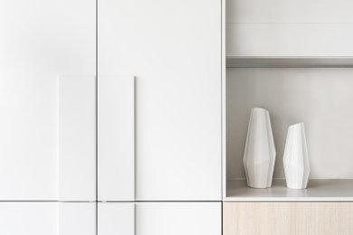 Immagine di una cucina design di medie dimensioni con ante bianche, top in quarzo composito, paraspruzzi bianco, pavimento in cemento e top bianco