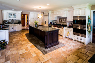 Example of a large mountain style u-shaped beige floor eat-in kitchen design in Philadelphia with white cabinets, multicolored backsplash, stainless steel appliances, an island, an undermount sink and raised-panel cabinets