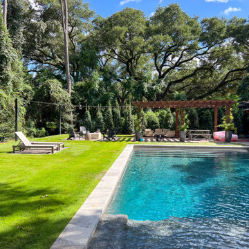 Modern Pool with outdoor living under massive oak trees
