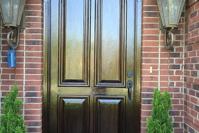 Example of a small classic entryway design in Louisville with a dark wood front door