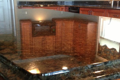 Inspiration for a mid-sized modern single-wall eat-in kitchen remodel in Detroit with granite countertops and an island