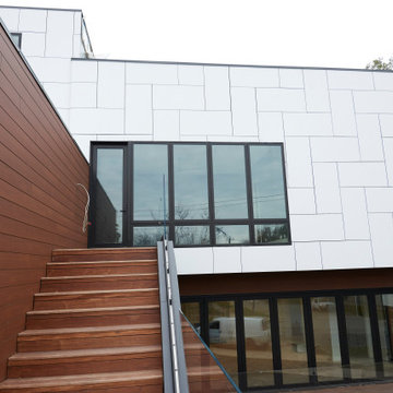 Striking Modern Facade with Trespa Panels and Expansive Glass