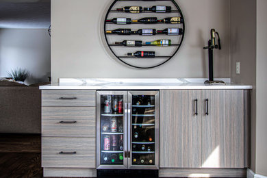 This is an example of a small transitional single-wall home bar in Cleveland with flat-panel cabinets, grey cabinets, quartz benchtops and white benchtop.