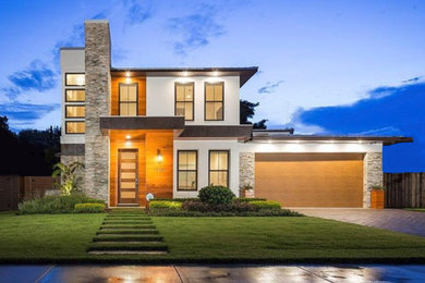 Mid-sized trendy white two-story stucco exterior home photo in Orlando with a metal roof
