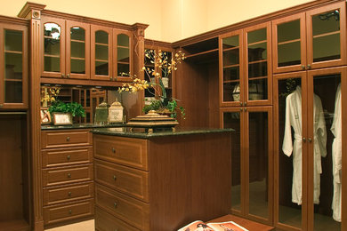 Design ideas for a large traditional gender-neutral storage and wardrobe in Orlando with raised-panel cabinets and brown cabinets.