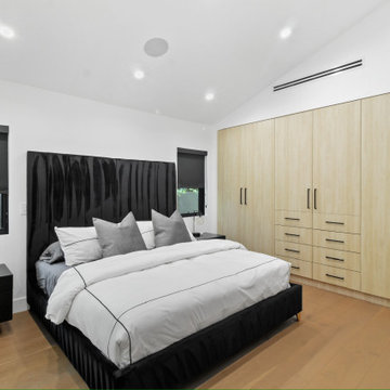 Bedroom with Full Wall of Oak Wardrobes and Drawer Bank