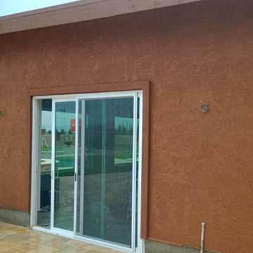 New construction pool house with mini split in landscaping.
