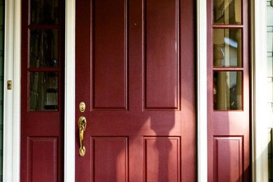 Inspiration for a timeless single front door remodel in San Francisco with green walls and a red front door