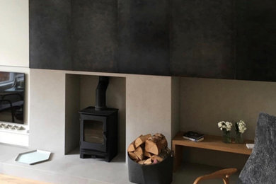 Inspiration for a scandi living room in Manchester with a wood burning stove and a stone fireplace surround.