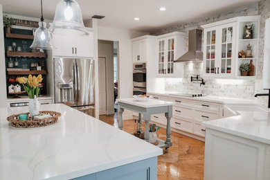 Inspiration for a mid-sized farmhouse open concept kitchen remodel in Miami with a farmhouse sink, stainless steel appliances and white countertops
