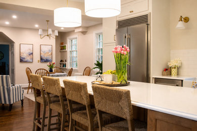 Large transitional u-shaped dark wood floor and brown floor eat-in kitchen photo in Baltimore with quartzite countertops, white backsplash, stainless steel appliances, an island, white countertops and porcelain backsplash