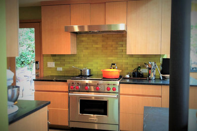 Enclosed kitchen - mid-sized contemporary l-shaped concrete floor and gray floor enclosed kitchen idea in Seattle with flat-panel cabinets, stainless steel appliances, an undermount sink, medium tone wood cabinets, quartz countertops, brown backsplash, subway tile backsplash and no island