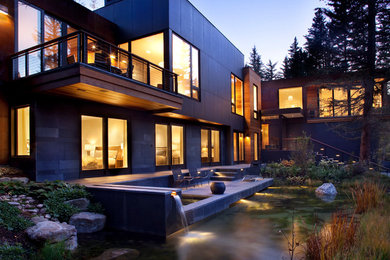 Mid-sized trendy two-story flat roof photo in Denver