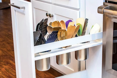 Large transitional galley medium tone wood floor and brown floor enclosed kitchen photo in Other with an undermount sink, white cabinets, quartzite countertops, white backsplash, stainless steel appliances, shaker cabinets, ceramic backsplash, a peninsula and multicolored countertops