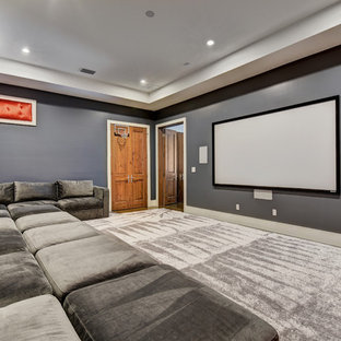 Home theater - mid-sized transitional enclosed carpeted and gray floor home theater idea in Austin with gray walls and a projector screen