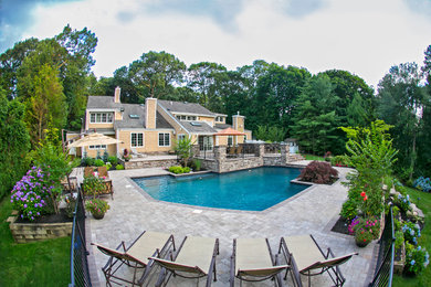 Pool - traditional backyard custom-shaped pool idea in New York
