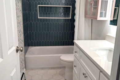 Alcove bathtub - mid-sized transitional kids' ceramic tile, multicolored floor, single-sink and wallpaper alcove bathtub idea in Boston with shaker cabinets, white cabinets, a one-piece toilet, white walls, an undermount sink, quartzite countertops, white countertops and a built-in vanity