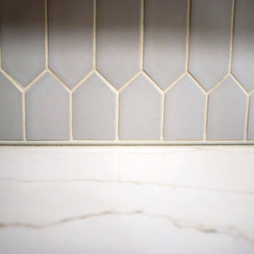 Two-Tone Neutral Kitchen with Quartz Countertop and Soho Picket Backsplash