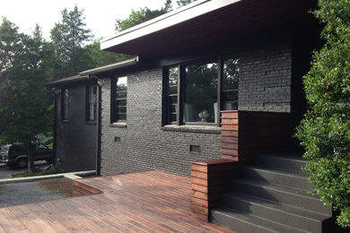 Large transitional black one-story brick exterior home photo in Nashville