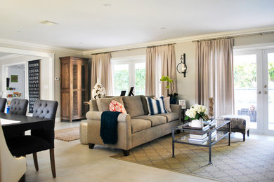 Example of a large open concept living room design in Miami with gray walls