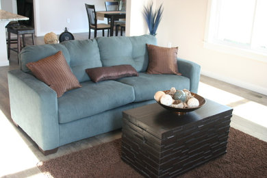 Trendy enclosed dark wood floor living room photo in Other