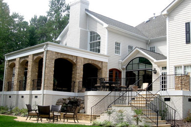 Inspiration for a large timeless white two-story brick gable roof remodel in Raleigh