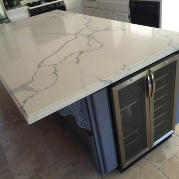 Kitchen blue cabinets island with Calacatta Gold Quartz countertops