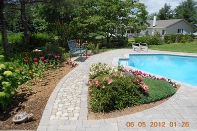 Inspiration for a large timeless backyard concrete paver and custom-shaped aboveground pool remodel in Baltimore