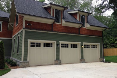 Large arts and crafts attached three-car garage photo in DC Metro