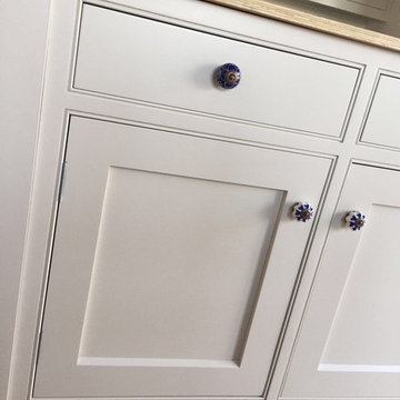 White Kitchen Cabinet with Patterned Handles