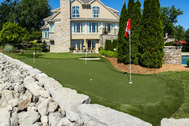This is an example of a large traditional partial sun backyard outdoor basketball/tennis/multi-game court in Toronto.