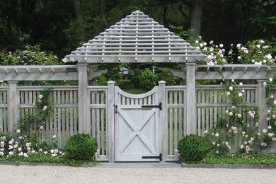 This is an example of a large traditional full sun front yard gravel formal garden in New York for spring.