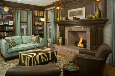 Family room library - mid-sized eclectic enclosed light wood floor and brown floor family room library idea in New York with gray walls, a standard fireplace, a brick fireplace and no tv