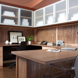 Inspiration for a medium sized modern study in Detroit with a built-in desk and red walls.