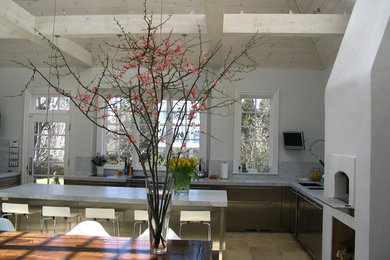 Large tuscan u-shaped limestone floor kitchen photo in New York with an undermount sink, flat-panel cabinets, stainless steel cabinets, marble countertops, white backsplash, stone slab backsplash, stainless steel appliances and two islands