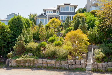 Inspiration for a contemporary front yard formal garden in Vancouver with a retaining wall.