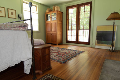 Traditional master bedroom in Bridgeport with a standard fireplace and beige floor.