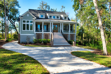 Elegant green two-story mixed siding exterior home photo in Other with a mixed material roof