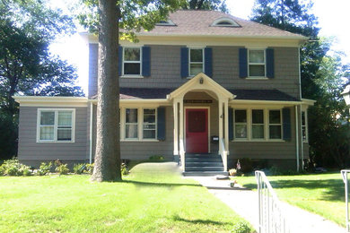 Example of a classic gray two-story wood exterior home design in New York