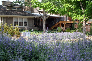 Design ideas for a large traditional partial sun backyard stone landscaping in Wichita.