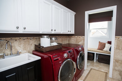Example of a mid-sized transitional single-wall ceramic tile dedicated laundry room design in Columbus with a drop-in sink, white cabinets and a side-by-side washer/dryer
