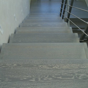 Modern metal stair covered by patina oak