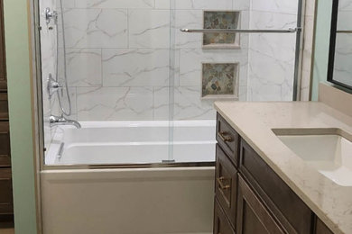 Alcove bathtub - mid-sized transitional master white tile and porcelain tile single-sink alcove bathtub idea in Cleveland with flat-panel cabinets, medium tone wood cabinets, a two-piece toilet, green walls, an undermount sink, quartz countertops, beige countertops, a niche and a built-in vanity