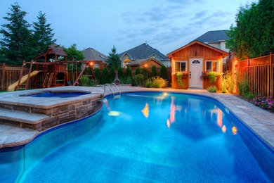 Photo of a mid-sized traditional backyard custom-shaped natural pool in Toronto with a pool house and natural stone pavers.