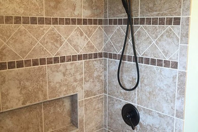Example of a mid-sized transitional master beige tile, brown tile, multicolored tile and stone tile bathroom design in Dallas with beige walls