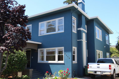 Large traditional blue two-story stucco exterior home idea in San Francisco
