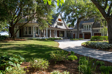 Inspiration for a large beach style two-storey grey house exterior in Charleston with wood siding.