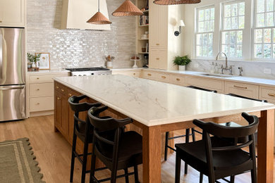 Inspiration for a mid-sized french country l-shaped kitchen pantry remodel in Other with beaded inset cabinets, medium tone wood cabinets, quartz countertops, white backsplash, stainless steel appliances, an island and white countertops