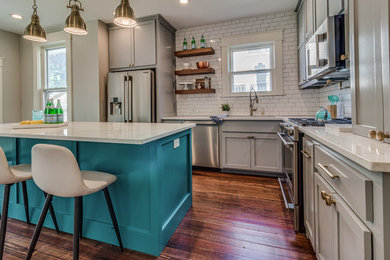 Minimalist galley kitchen photo in Oklahoma City with shaker cabinets, quartz countertops, white backsplash, porcelain backsplash and an island