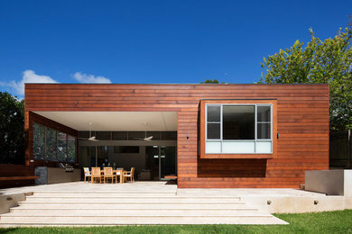 Design ideas for a contemporary exterior in Sydney with wood siding and a flat roof.